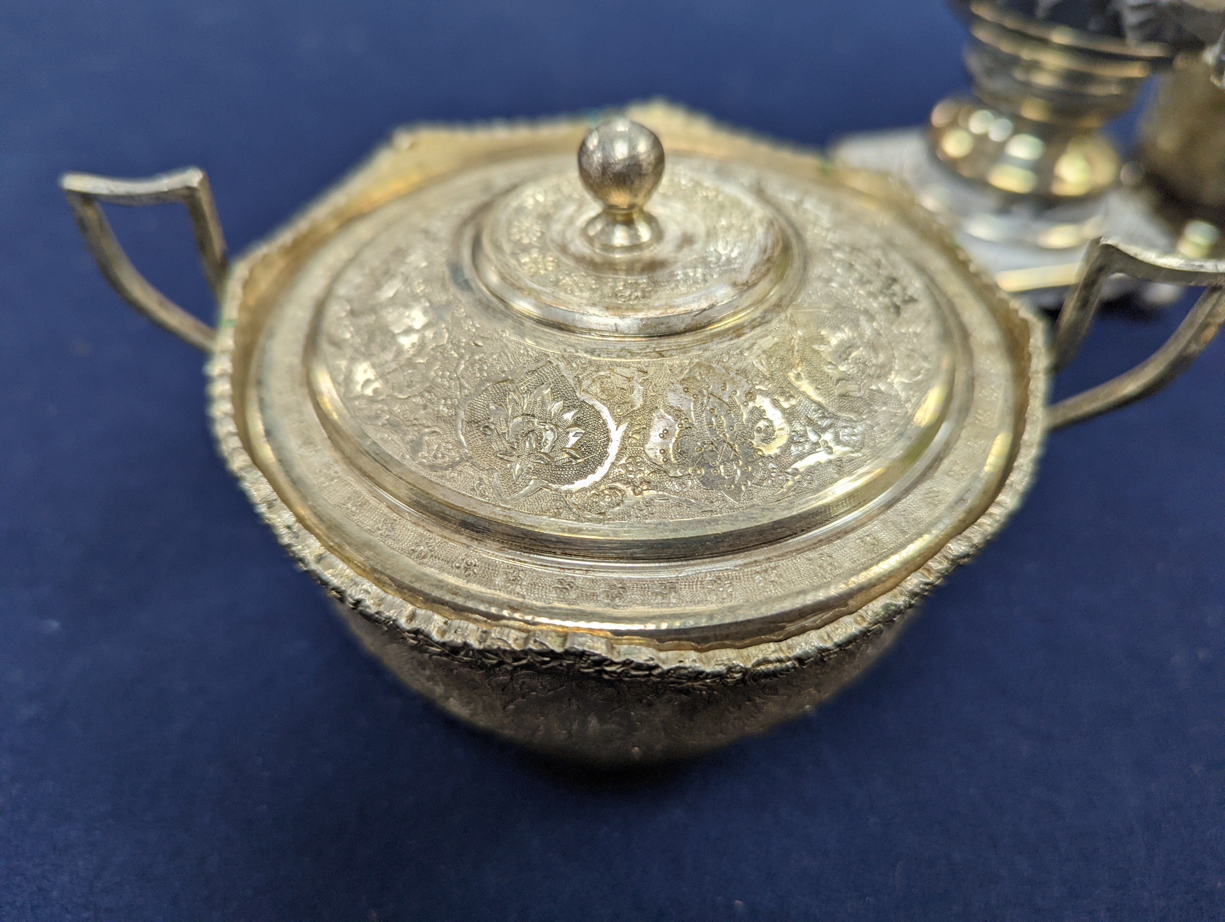 A set of six Persian embossed 84 standard white metal coffee cup holders and matching sugar bowl and cover by Vartan and four other Persian white metal items.
